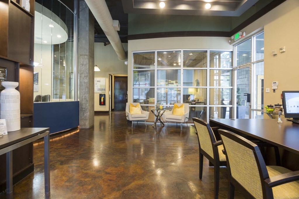 a room with a table and chairs and a large window