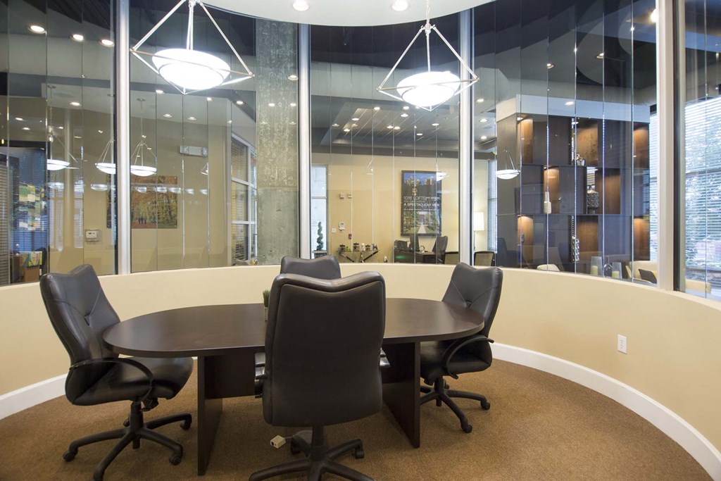 a conference room with large windows and a table and chairs