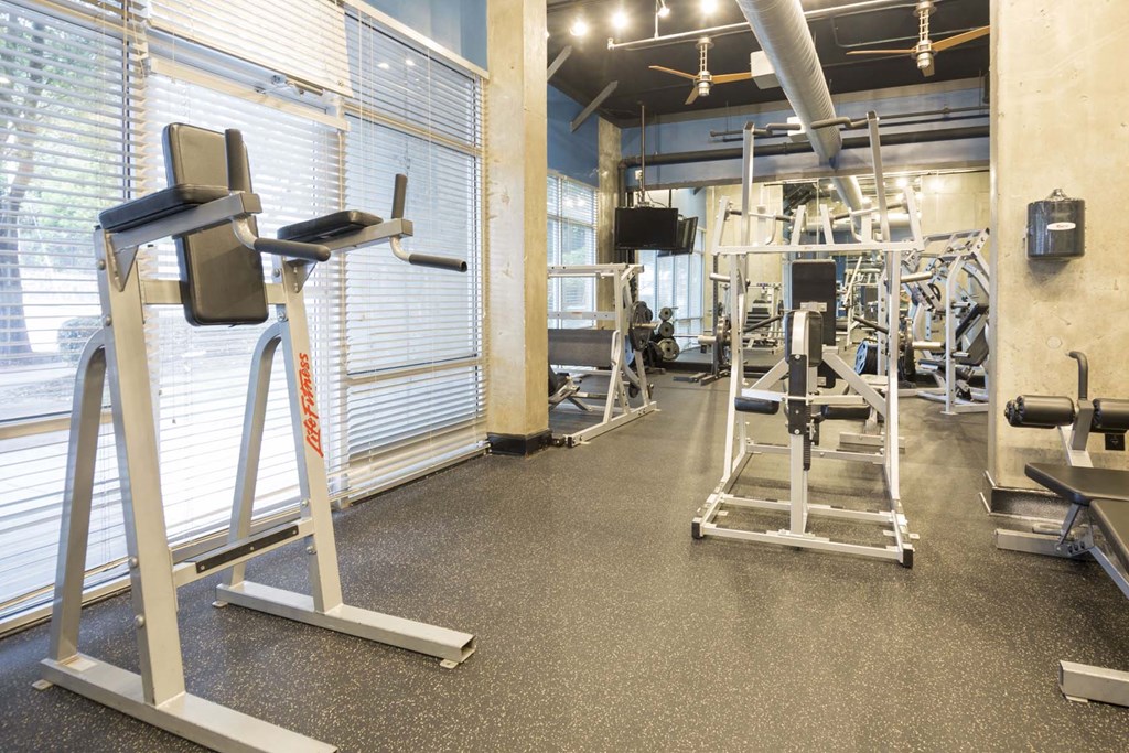 a workout room with a variety of exercise equipment