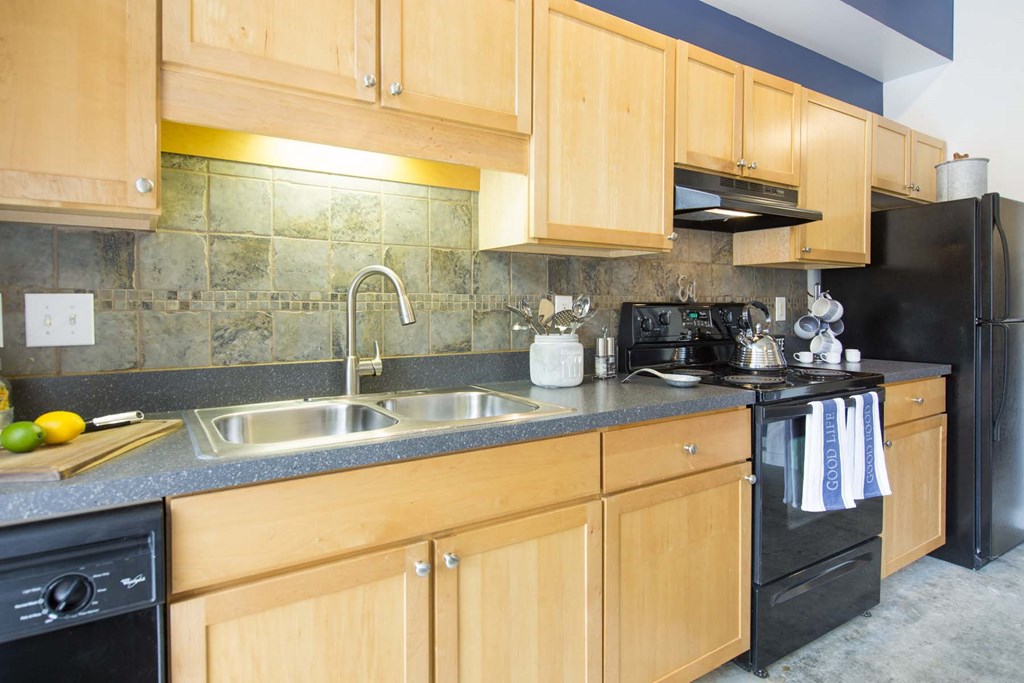 a kitchen with wooden cabinets and black appliances