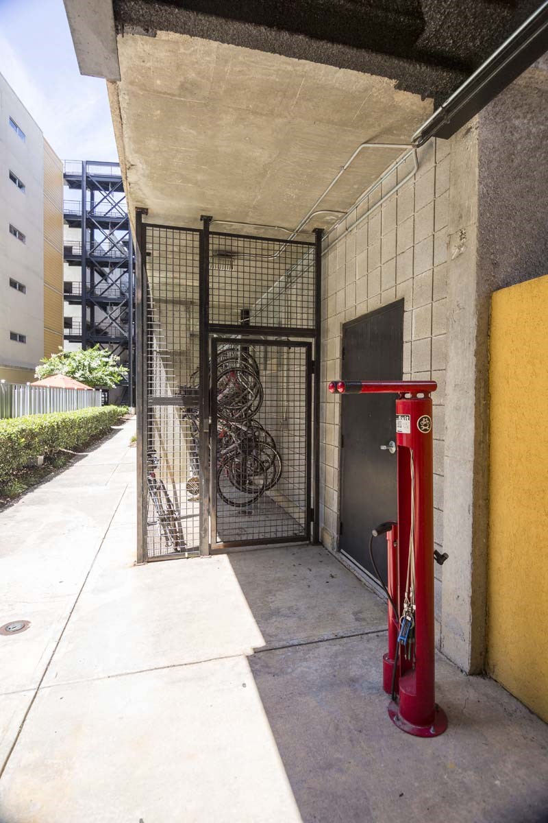 a red fire hydrant sitting next to a metal gate