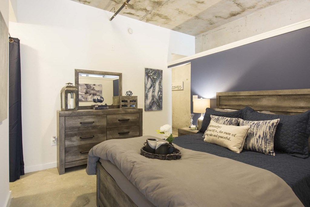 a bedroom with a bed and a dresser