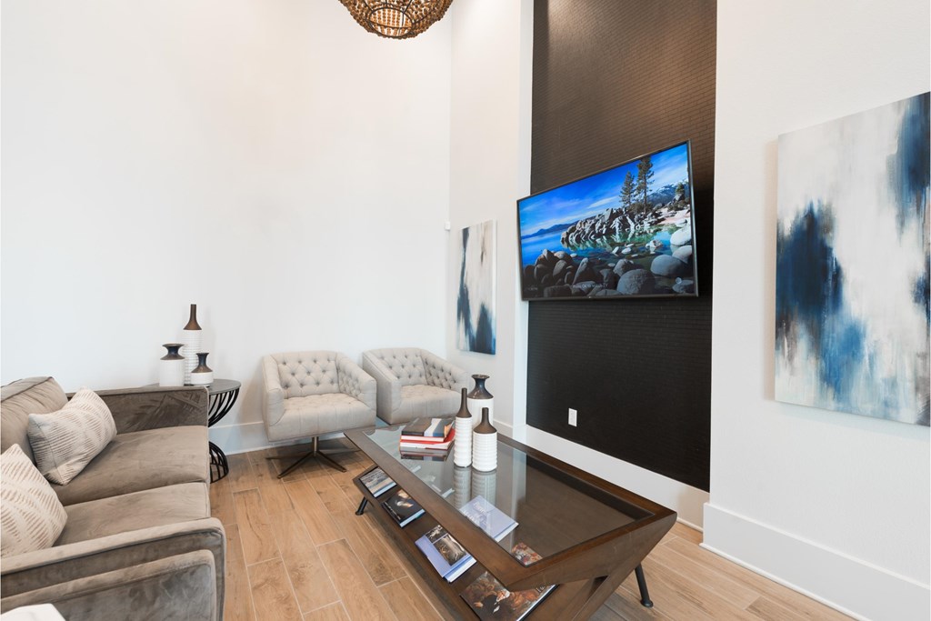 a living room with a couch and a coffee table and a tv
