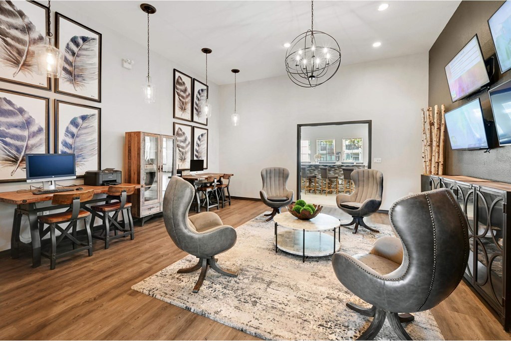 a living room with chairs and a tv