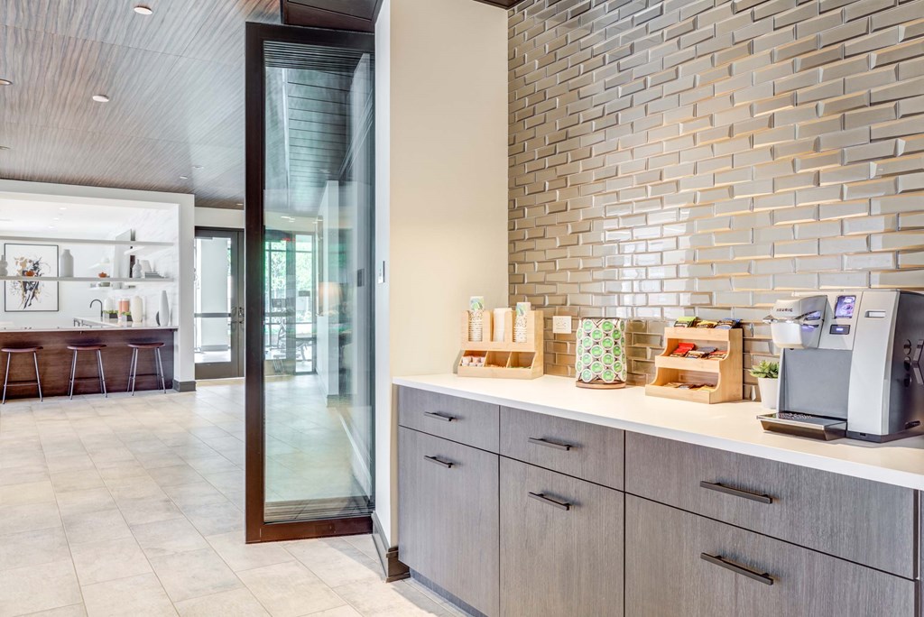 A kitchen with a counter and a wall of tiles.