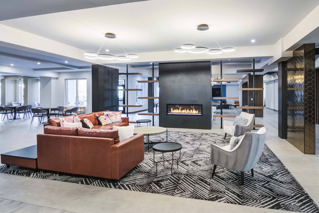 The Beacon lounge with couches, chairs, and in-wall fireplace