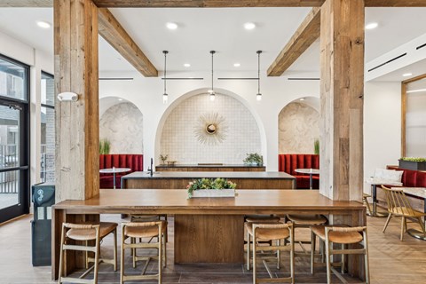 A modern dining area with a wooden table and chairs.