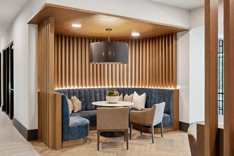 A modern dining area with a wooden table and chairs.