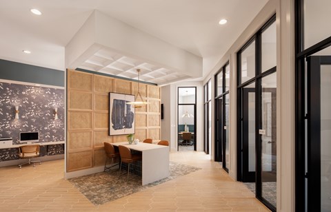 A modern office space with a wooden reception desk and chairs.