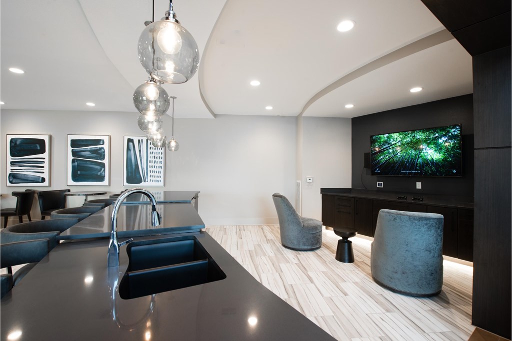 a living room with a kitchen and a television