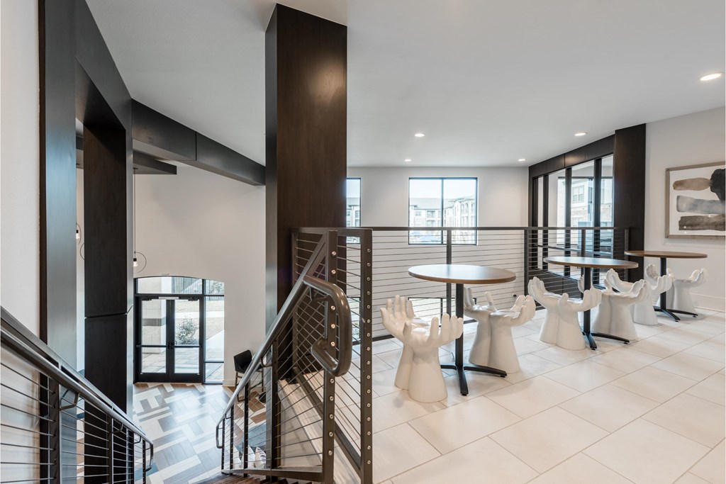 a dining room with chairs and tables and a staircase