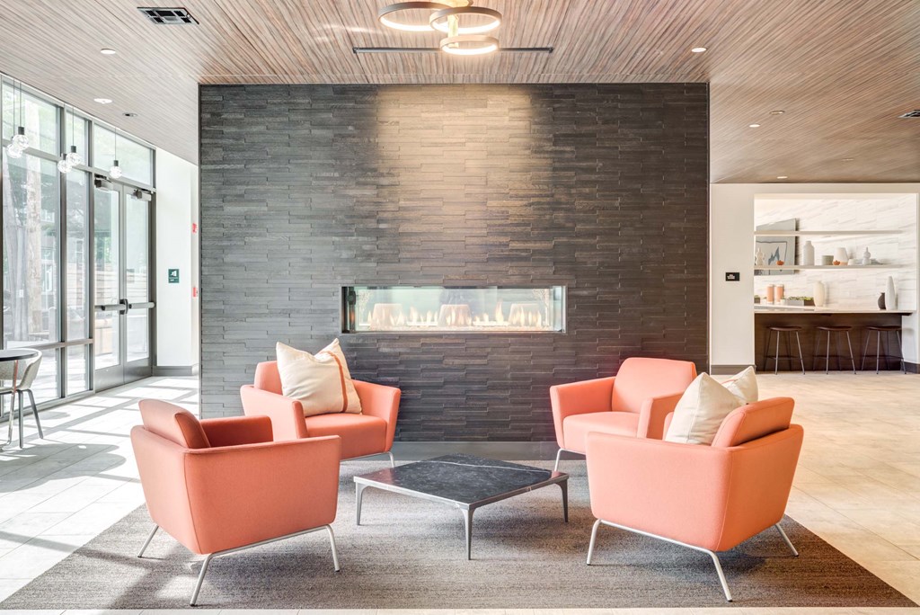 A living room with a fireplace and two chairs.