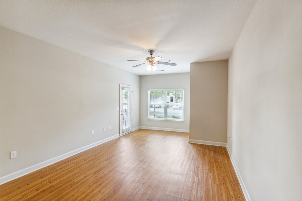 a bedroom with hardwood floors and a ceiling fan