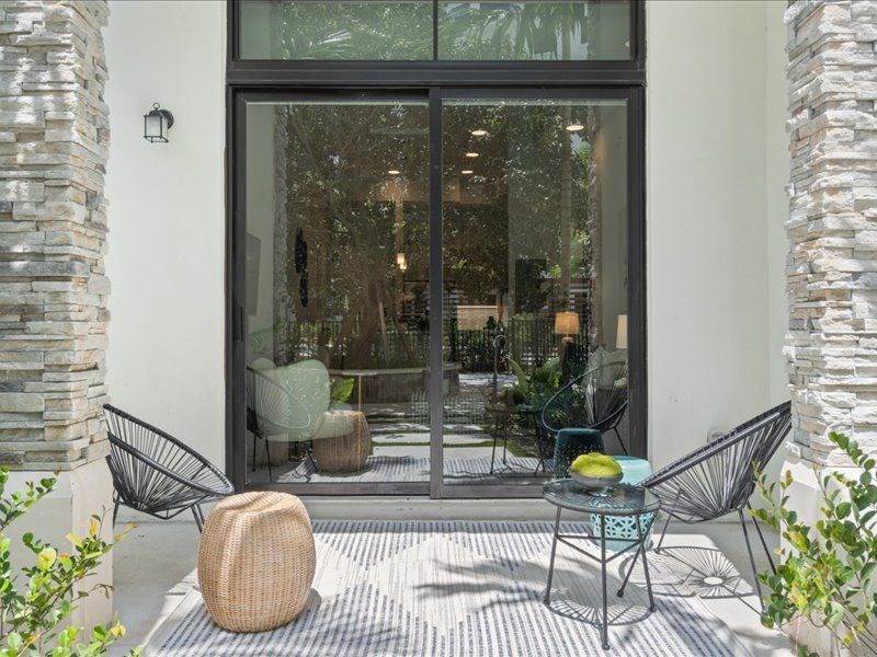 a patio with chairs and a table