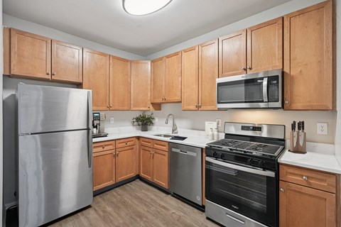 A kitchen with wooden cabinets and stainless steel appliances.