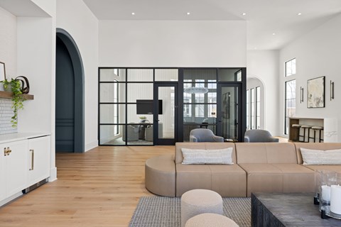 A modern living room with a large couch and a fireplace.