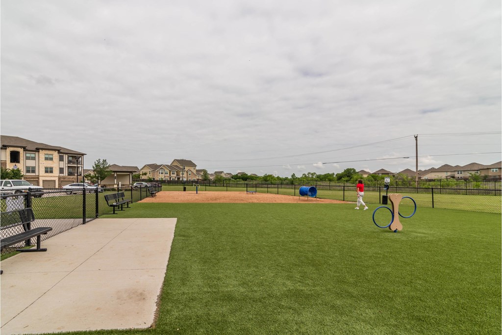 a man is standing on a baseball field at a park