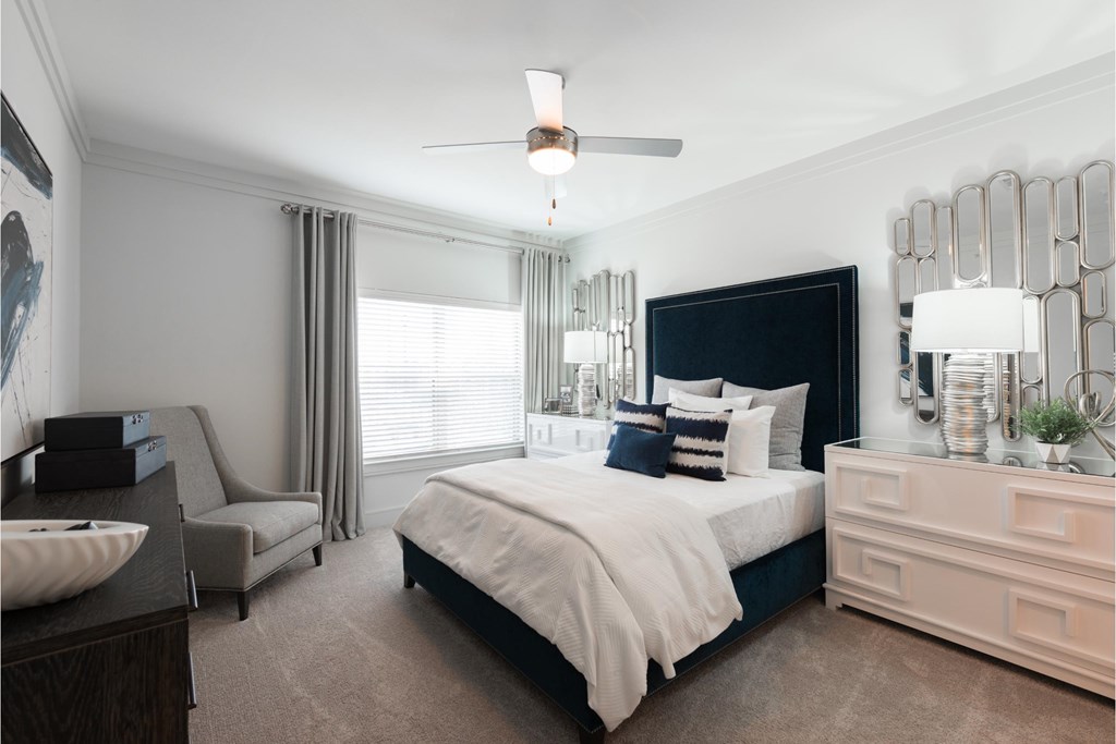 a bedroom with a bed and a dresser and a window