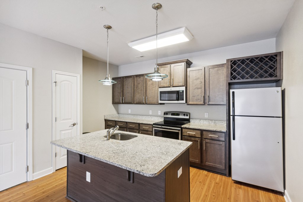 a kitchen with an island and stainless steel appliances