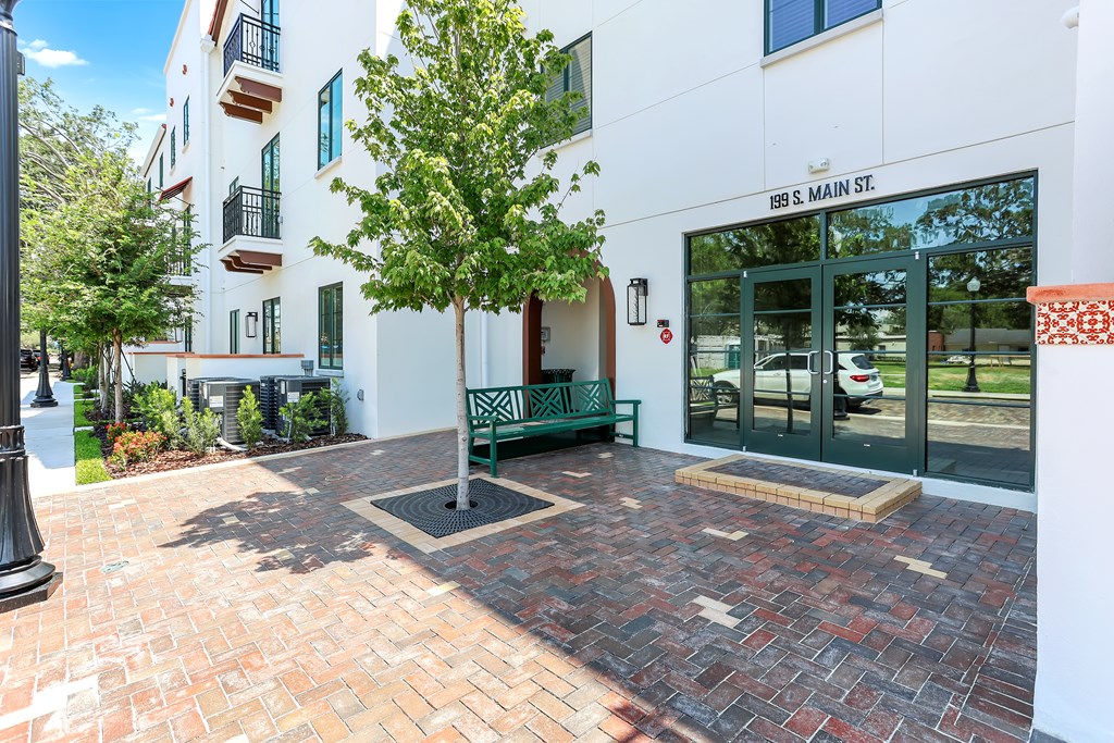 a bench in front of a building with a glass door