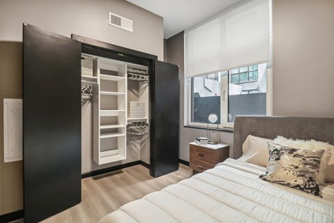 a bedroom with a bed and a closet