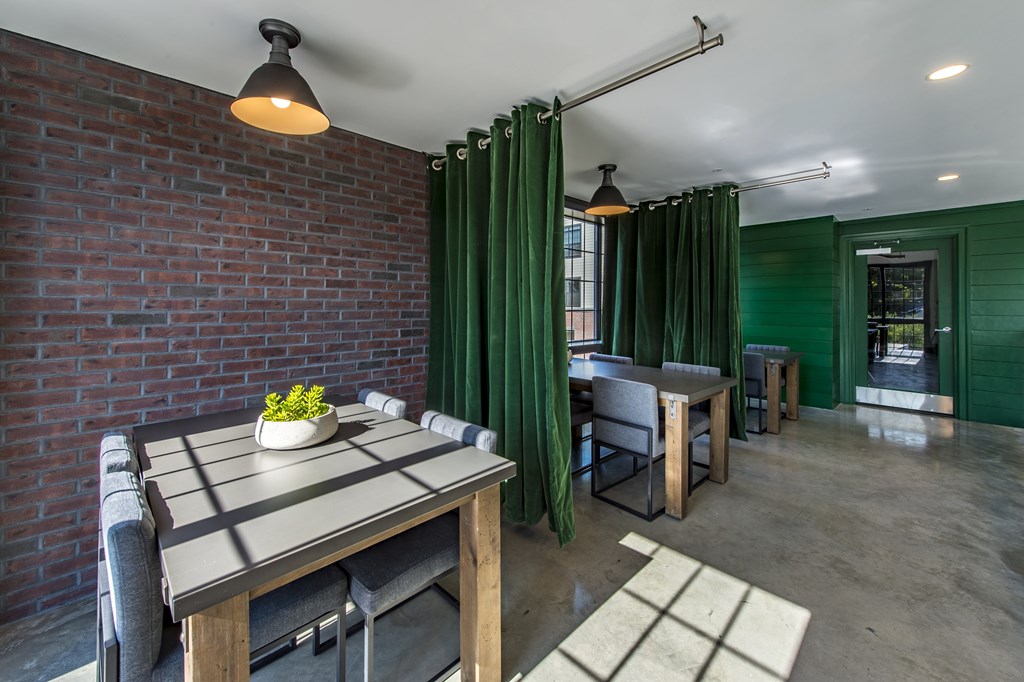 A dining area with a table and chairs.