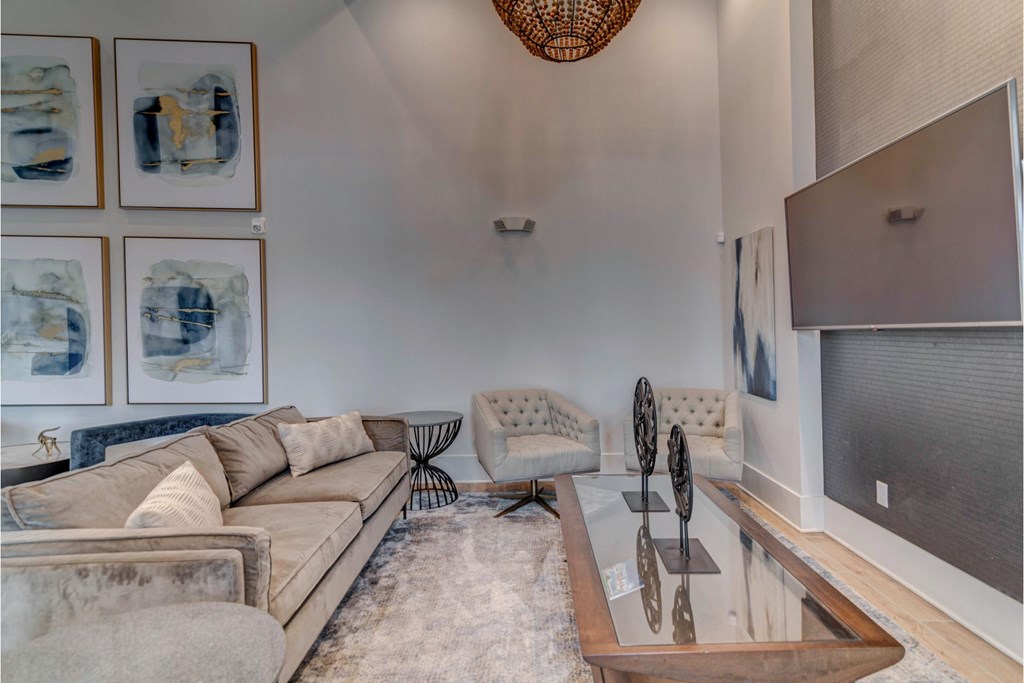 a living room with a couch and a glass coffee table