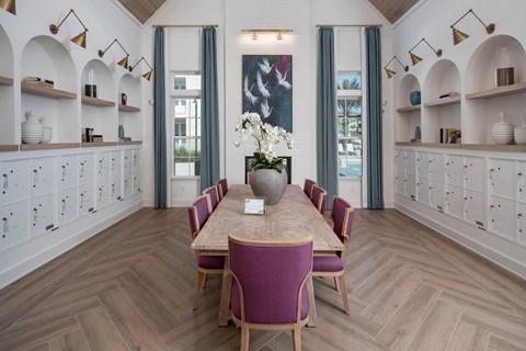 a dining room with a wooden table and purple chairs