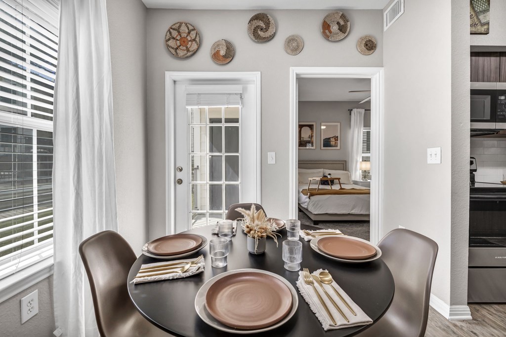 a dining room with a table and chairs