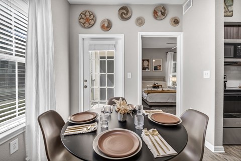 a dining room with a table and chairs
