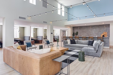 A living room with a large sectional sofa and a coffee table.