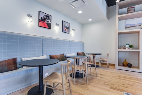 A dining area with a table and chairs.