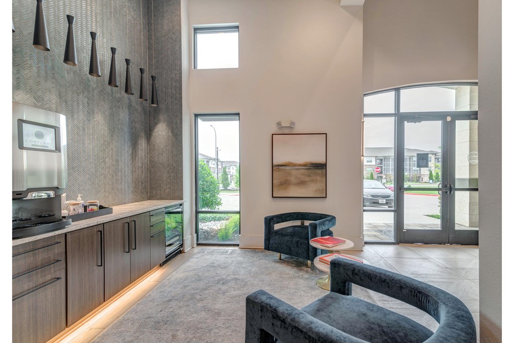a living room with a couch and a table and a kitchen