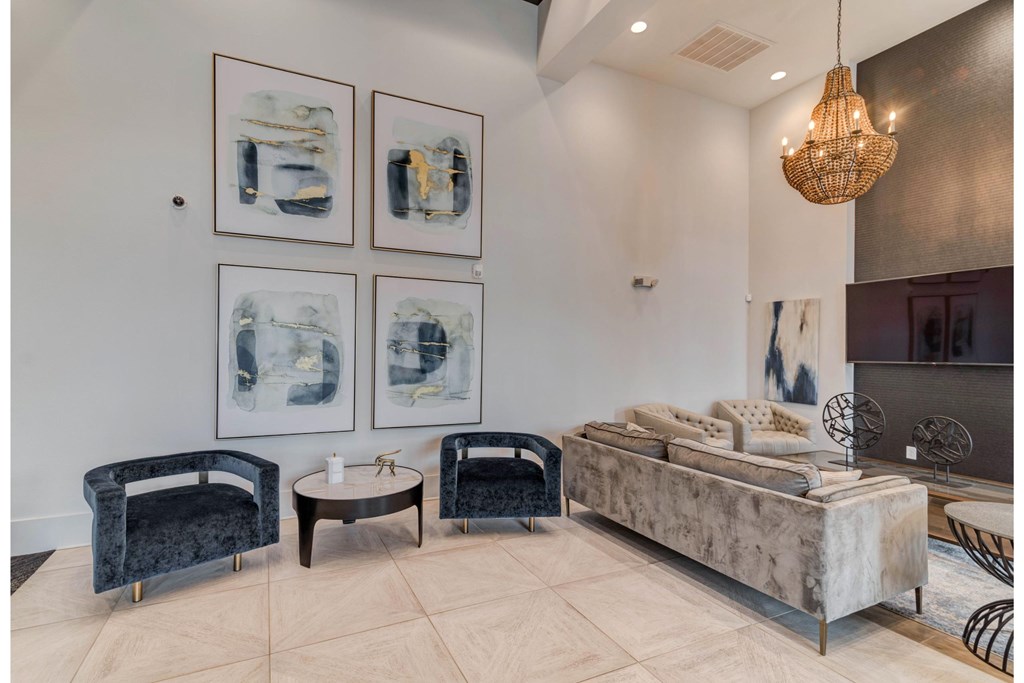 a living room with couches and chairs and a chandelier