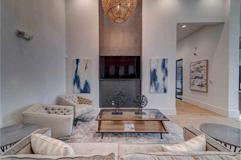 a living room with couches and a coffee table and a fireplace