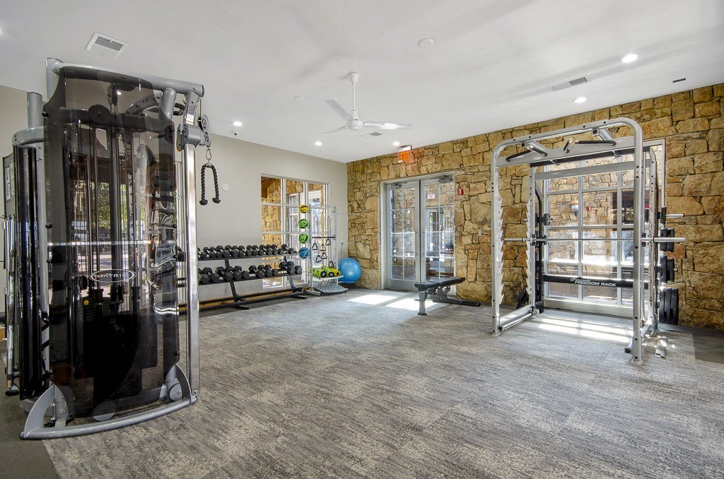 Fitness center with strength training equipment and free weights