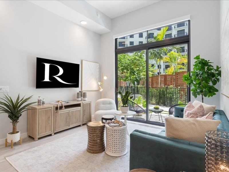 a living room with a blue couch and a large window