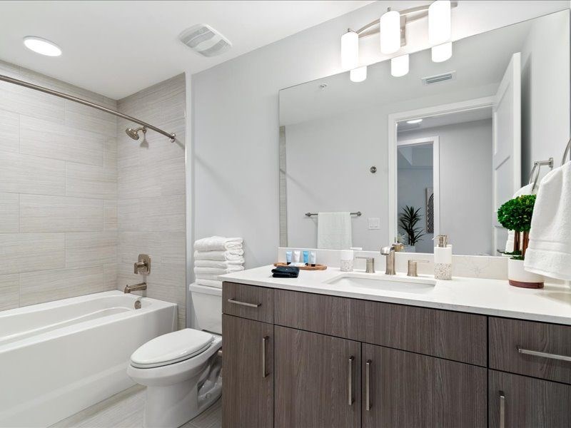 a bathroom with a toilet and a sink and a mirror