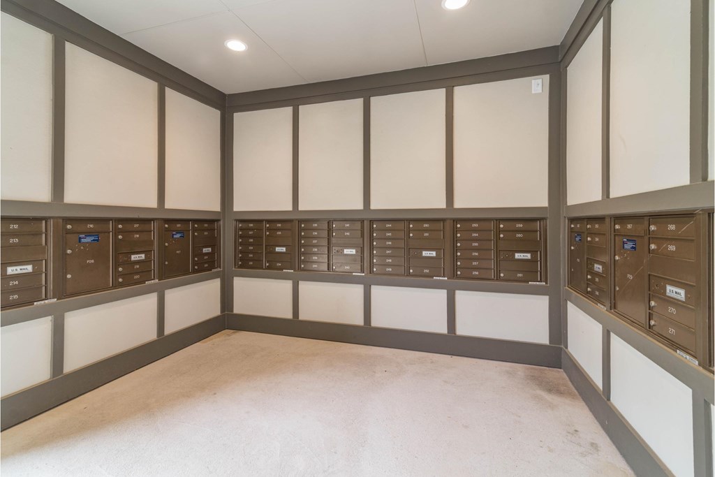 a locker room with white walls and rows of lockers