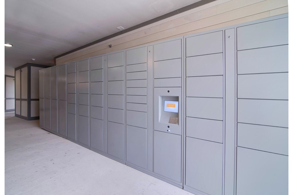 a large white storage room with a door to a safe deposit box