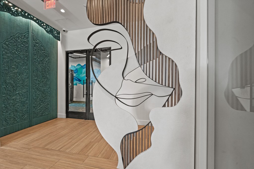 A white wall with a black and white face cut out.