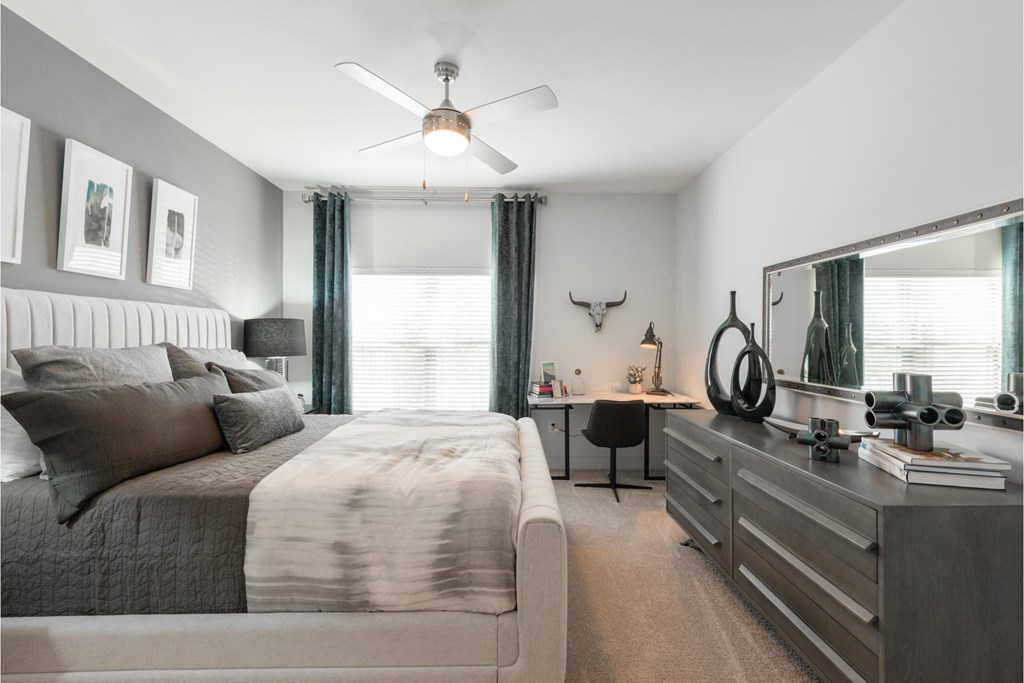 a living room with couches and a desk and a television