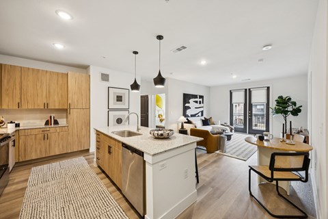 A modern kitchen with wooden cabinets and a white island.
