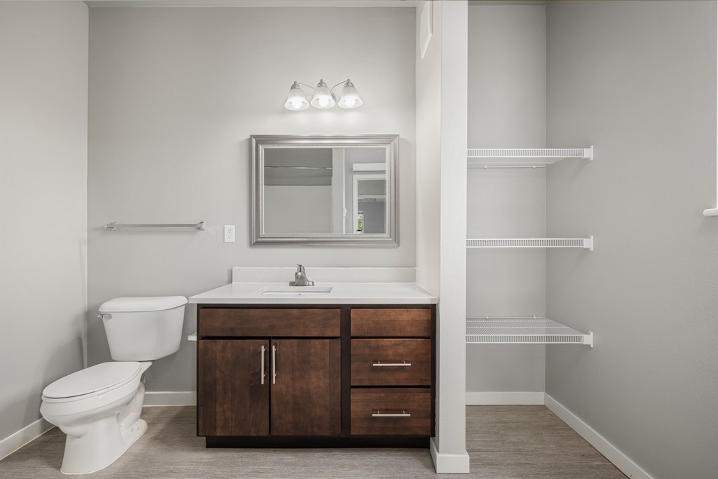 an empty bathroom with a toilet sink and mirror