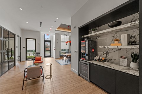 A modern kitchen with a marble countertop and a seating area with chairs and a table.