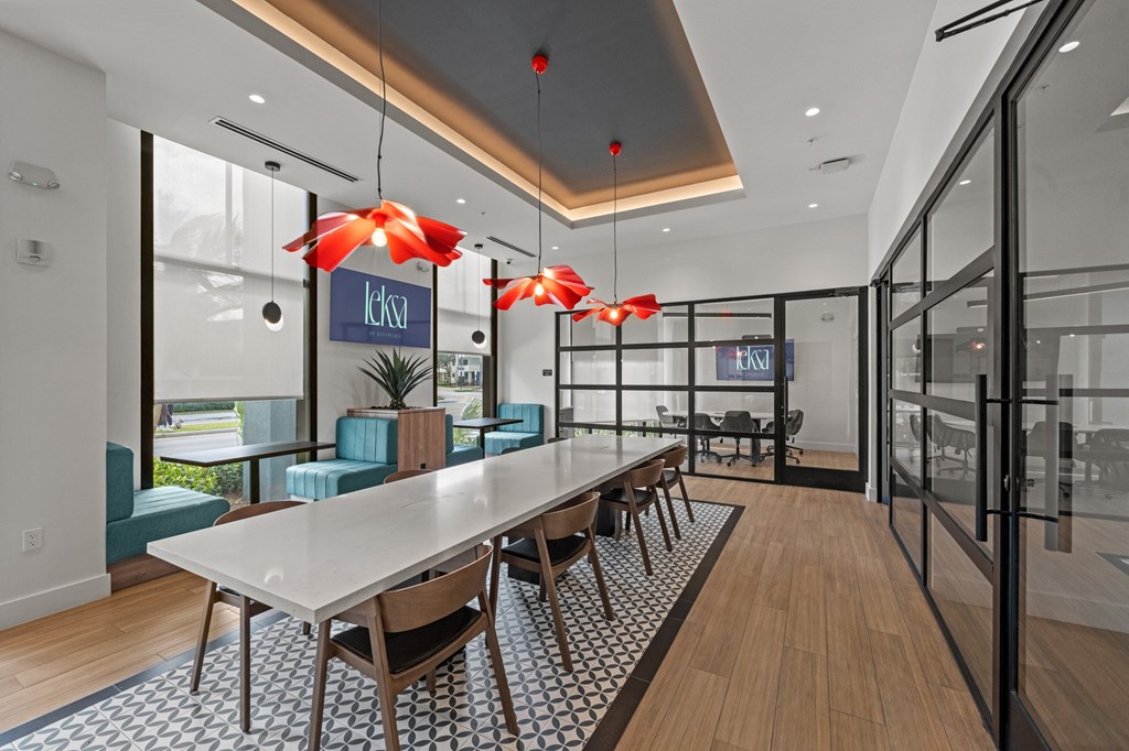 A modern dining area with a long table and chairs.