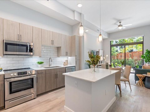 a kitchen with an island and a stove and a microwave