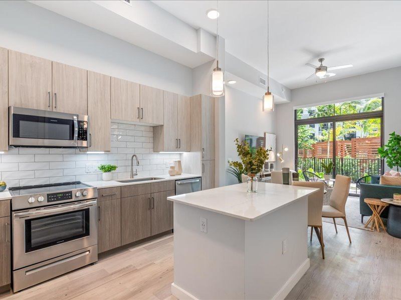 a kitchen and living room with a large window