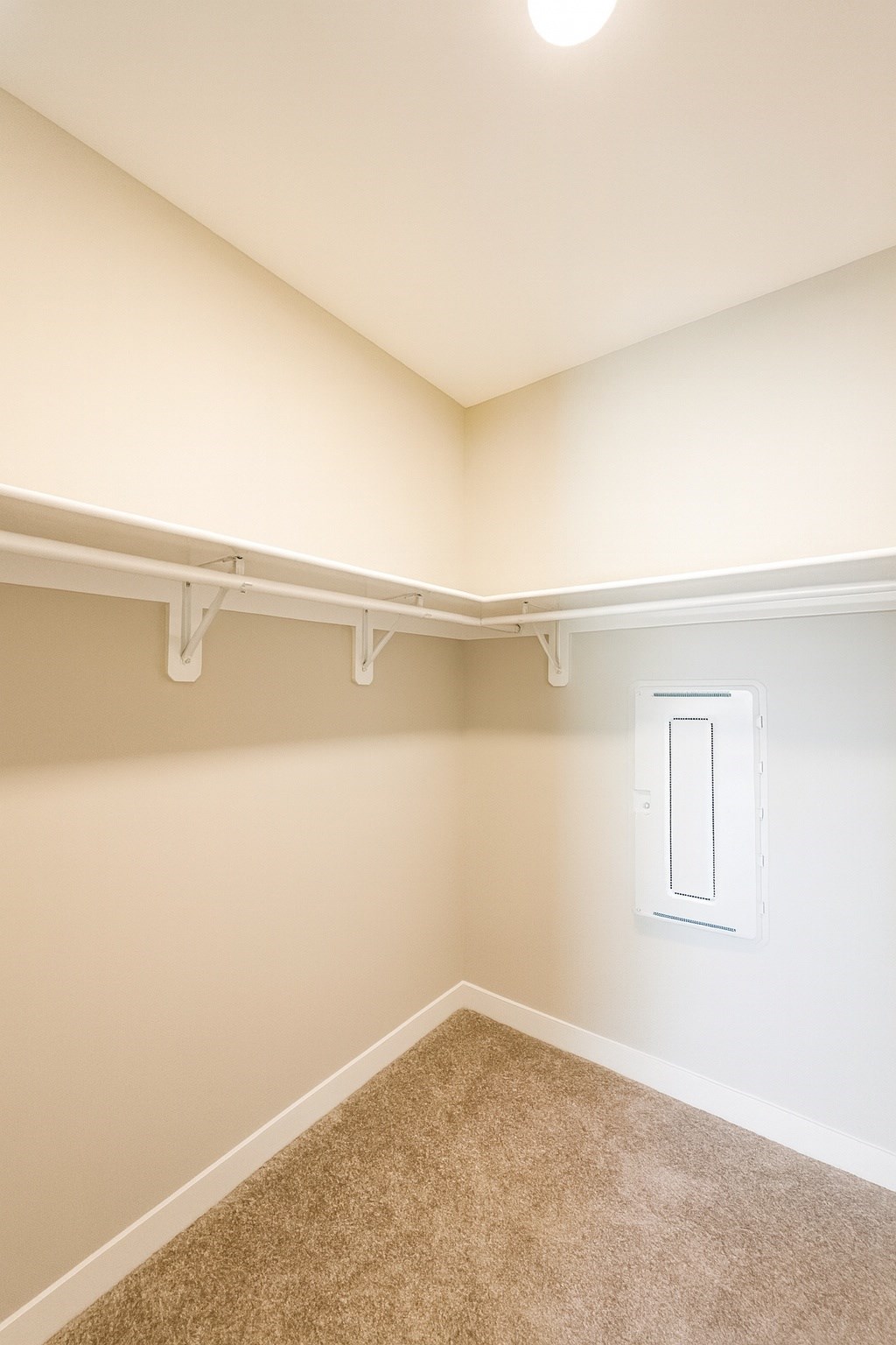 A white light switch on a beige wall.