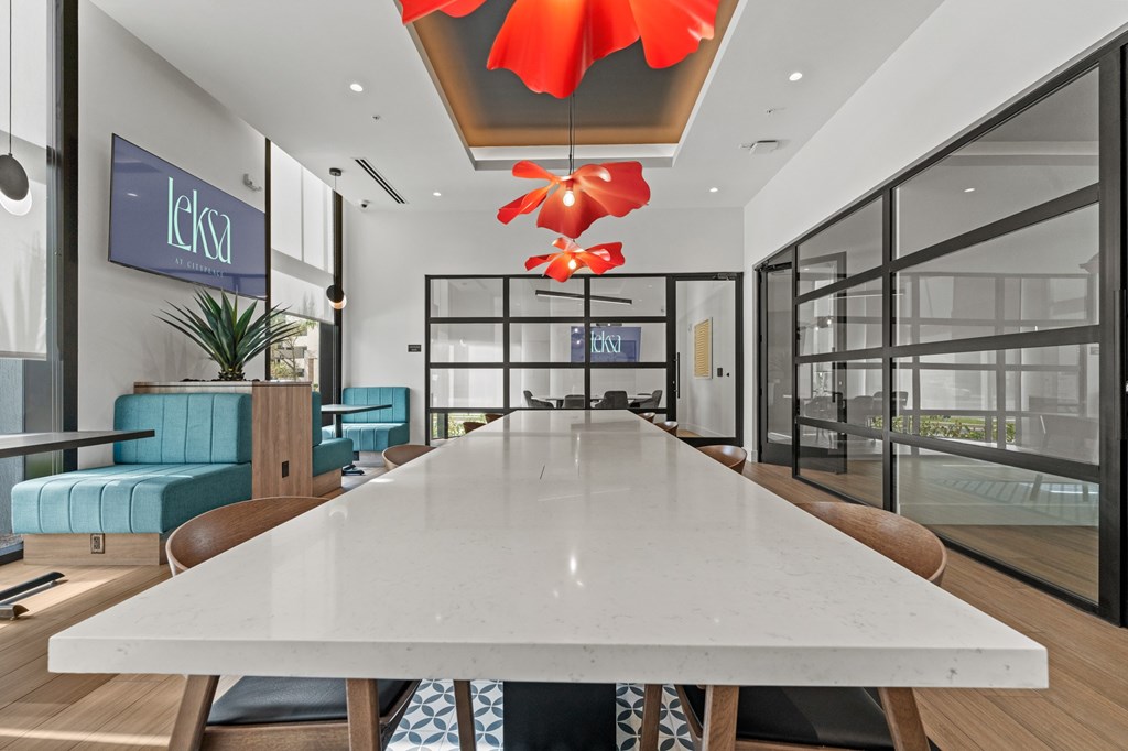 A modern dining area with a long table and chairs.